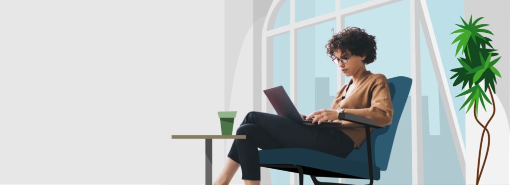 Frau mit gelocktem Haar arbeitet am Laptop